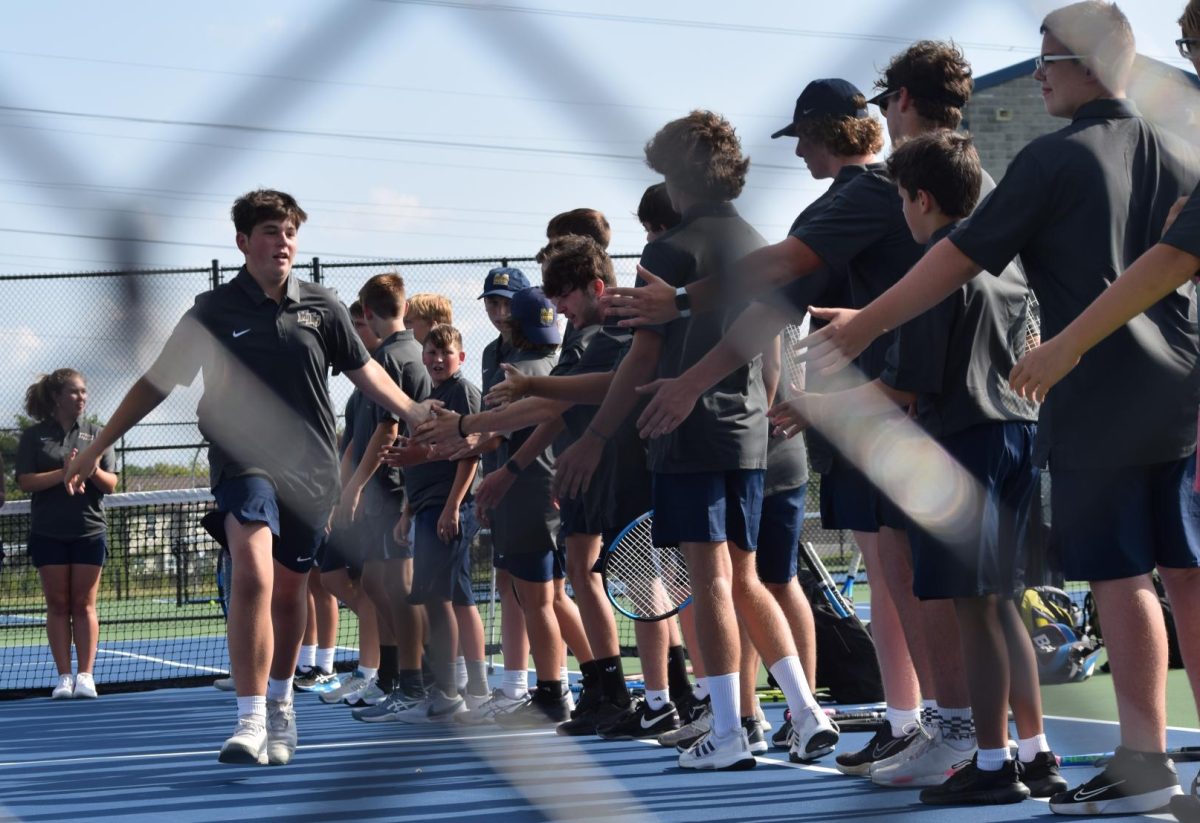 The varsity boy's tennis team is preparing for the scrimmage against Decatur. Each teammate was announced and given a chance. "", 