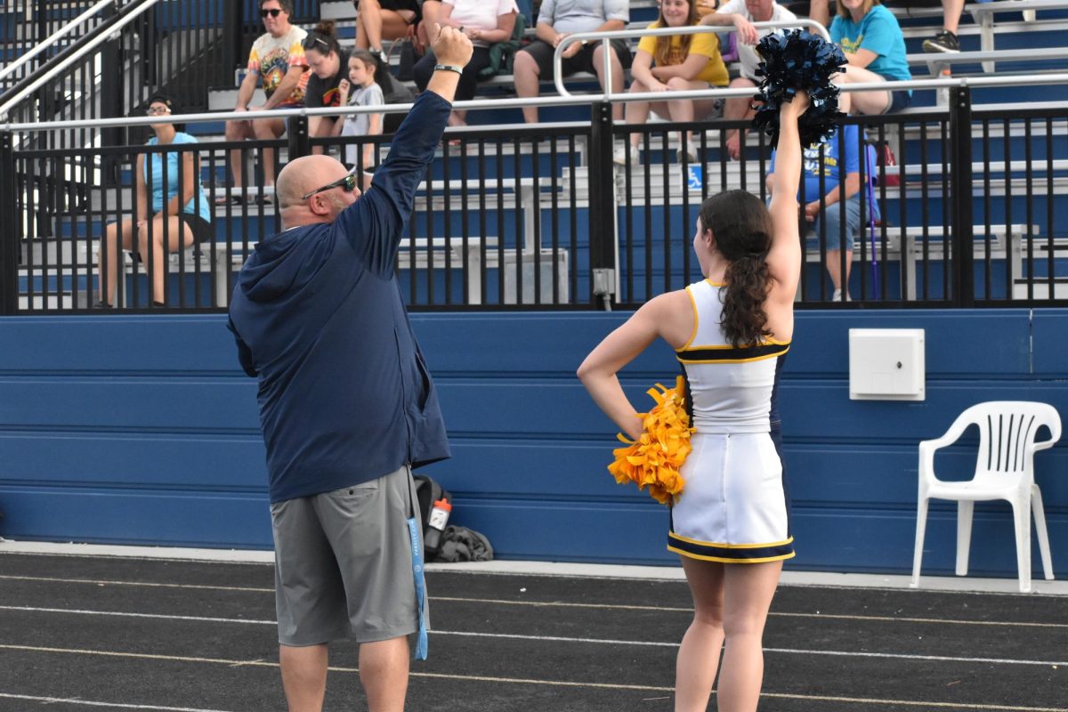 Junior Ruth Parker hypes up the crowd alongside Principal Wes Upton.