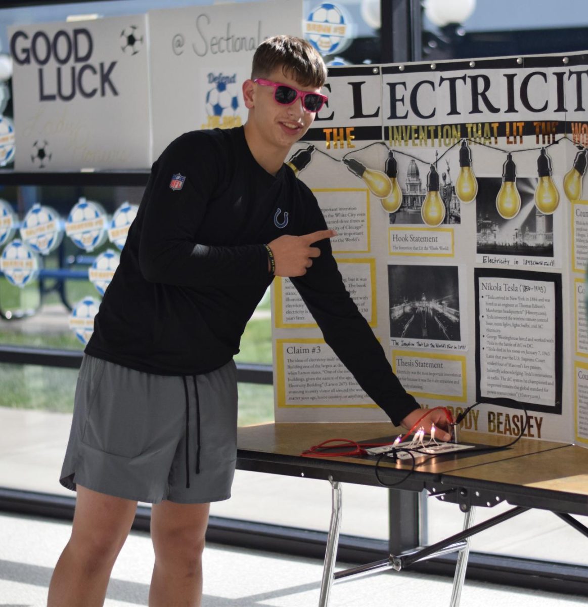 Freshman Brody Beasley demonstrates how his model of the electricity from the fair actually lights up.