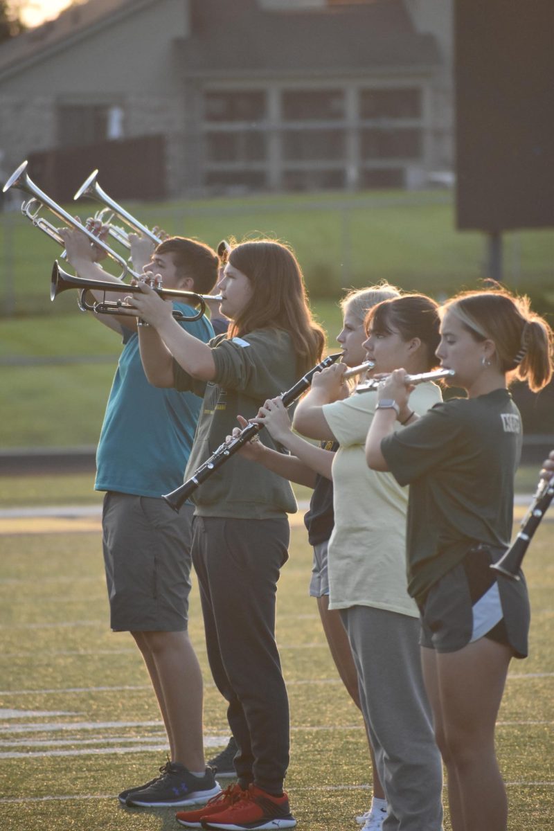 Band students are practicing their routine in the hot afternoon sun. These students spent hours perfecting their performance. “Marching band is really tiring but really fun,” said junior Masyn Boicourt.