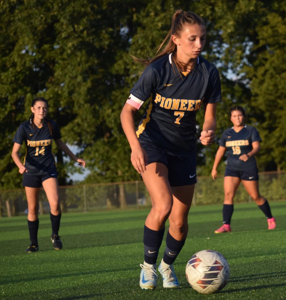 Junior Lyla Jacobs passes the ball around her New Palestine opponents. 12 years of soccer comes with a lot of experience and tips and tricks from others, including her Grandpa, whom gave her her favorite piece of advice. “Keep shooting, you can’t score if you don’t shoot,” Jacobs said.