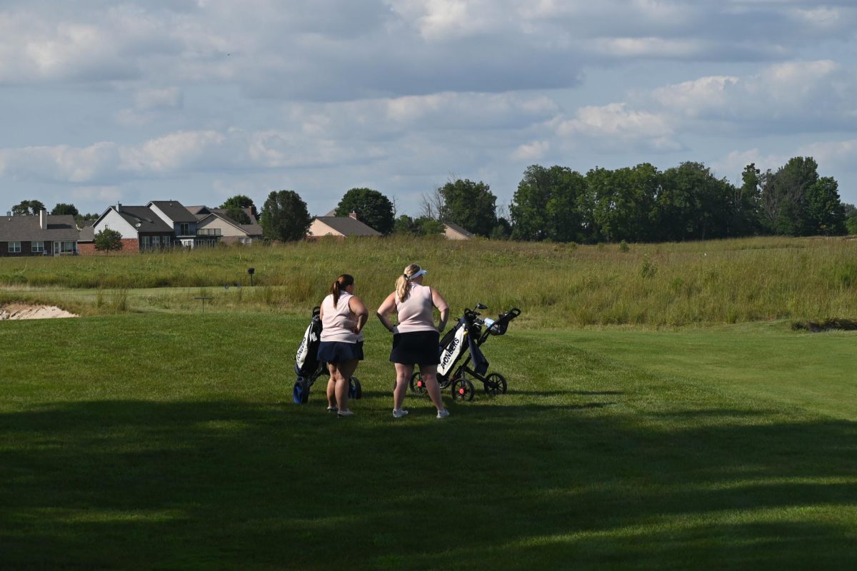 Benelisha and Addair discuss the previous hole. They had a long evening ahead of them. "I think golfing with Eloise helps me golf better, because it helps me laugh off the bad shots and the bad holes," Addair said.