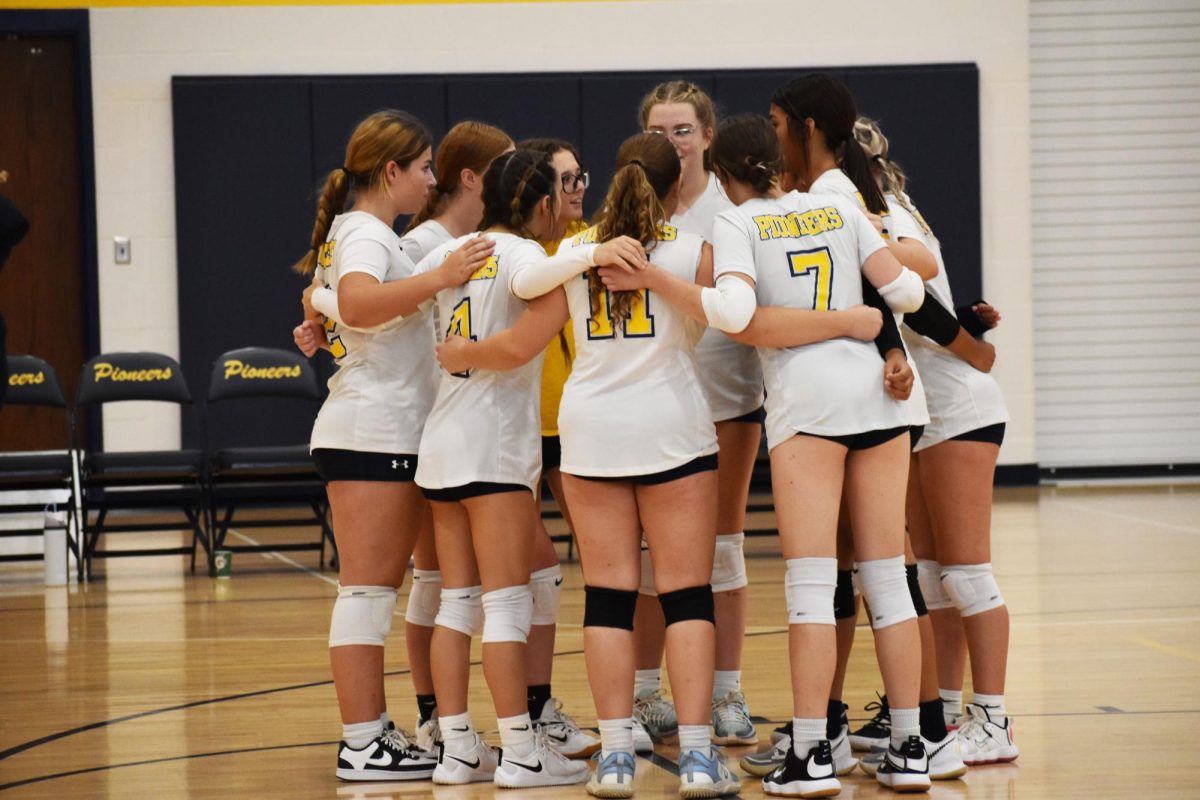 The girls huddle up before their game starts. They played against Bloomington south.  “We talk about what we need to work on and it is not a win or a loss,” freshman Caroline Curran said.