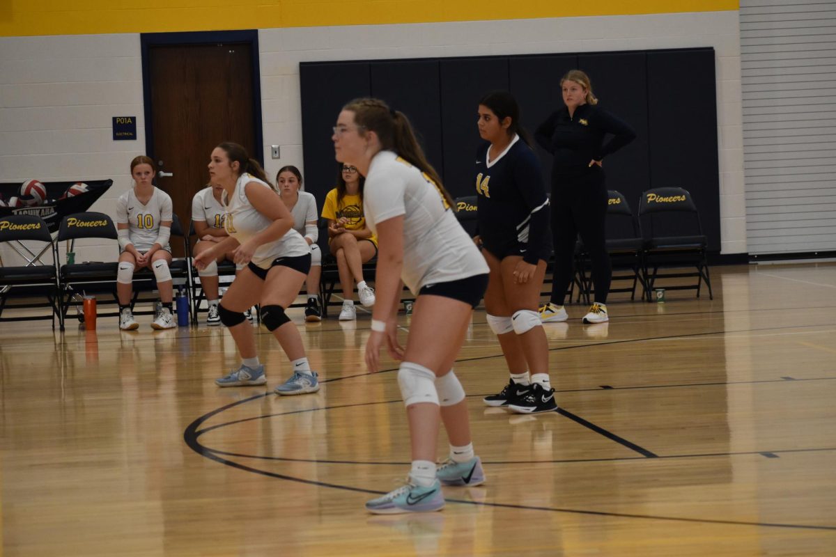 Freshman Ella Bey preps as the other team serves the ball. She is very excited for this year. “Not getting into my head helps me a lot,” Bey said.