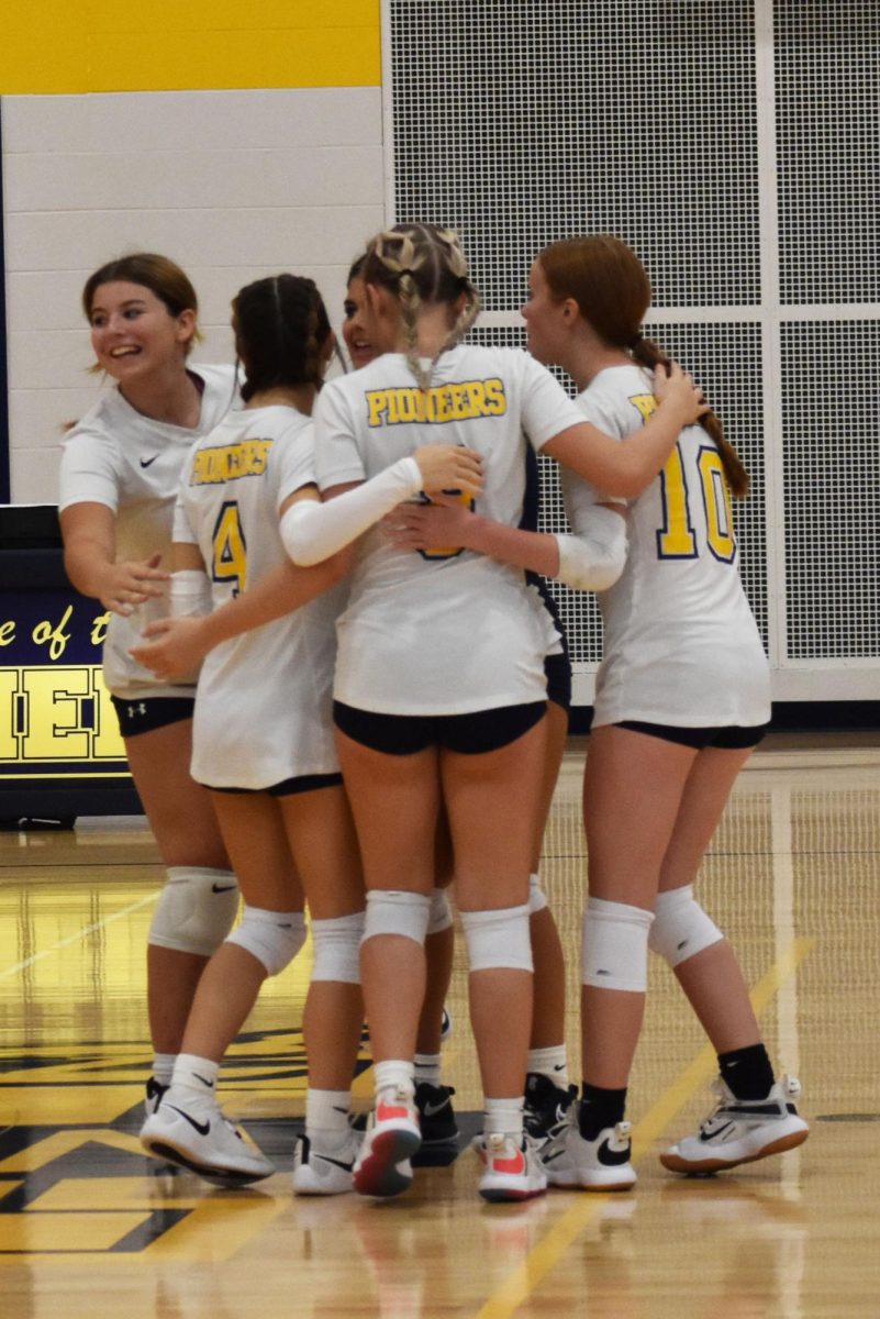 The team celebrates after scoring. Huddling is a way to make sure everyone is okay. “It makes us excited when we score a point,” freshman Kennidy Wilson said.