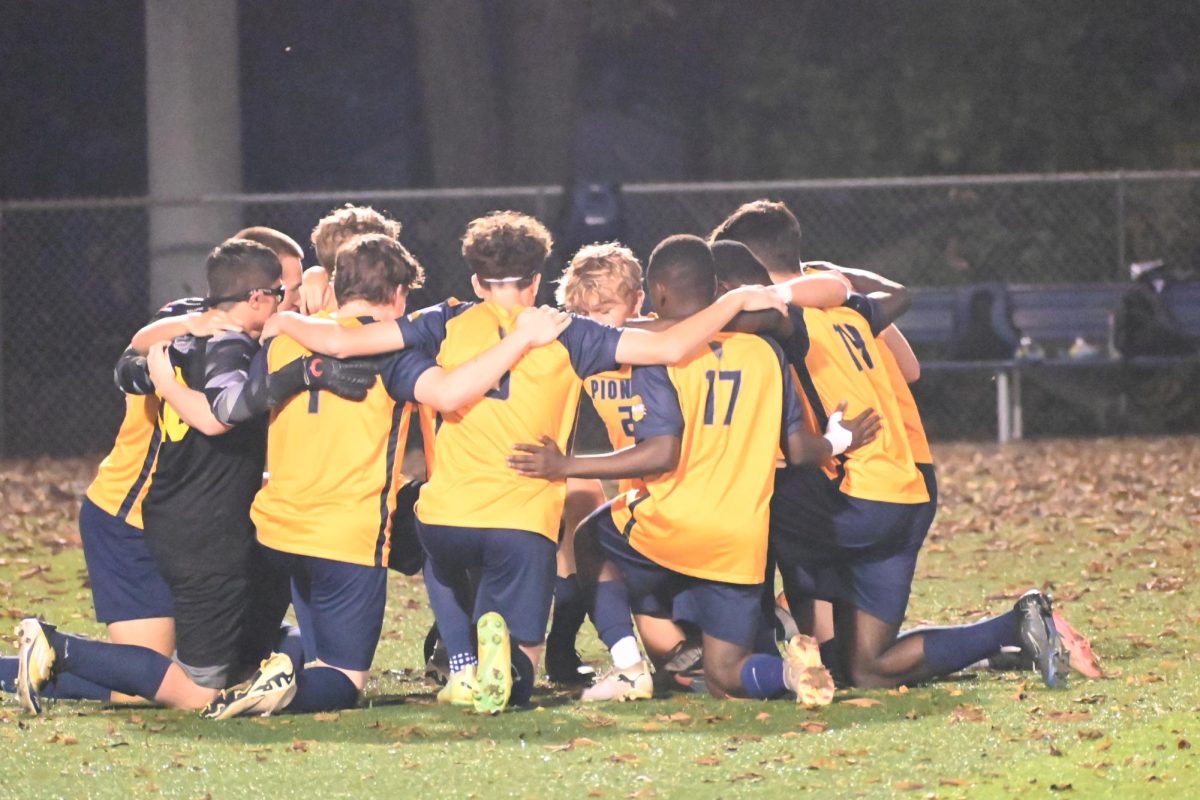 The team comes together in a huddle just before the game starts. The team went on to end the game in a tie of three to three.