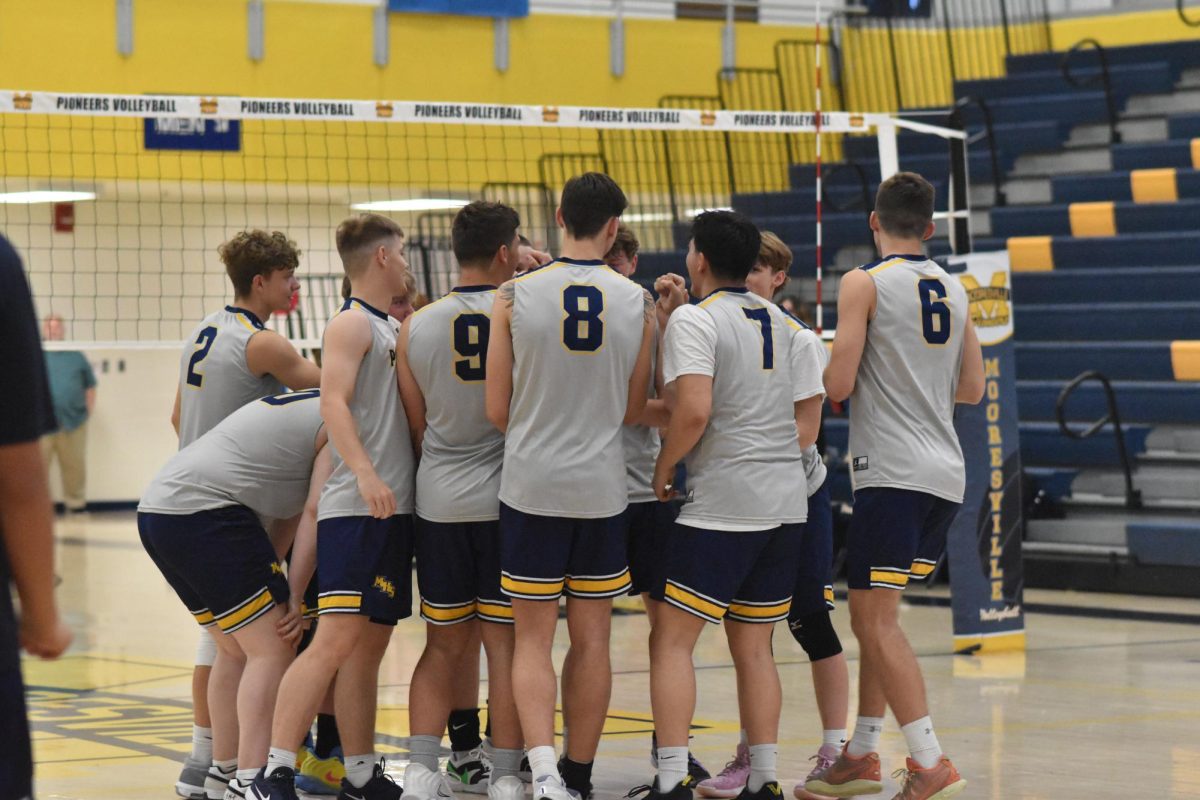 The team gathers around each other to do a breakout yell before the game begins. The team went on to win the game with a sweep of 3-0. "I feel this is one of our best seasons yet, I think we're doing a lot of good things, and I'm excited to see where this season takes us," junior Matthew Dale said.