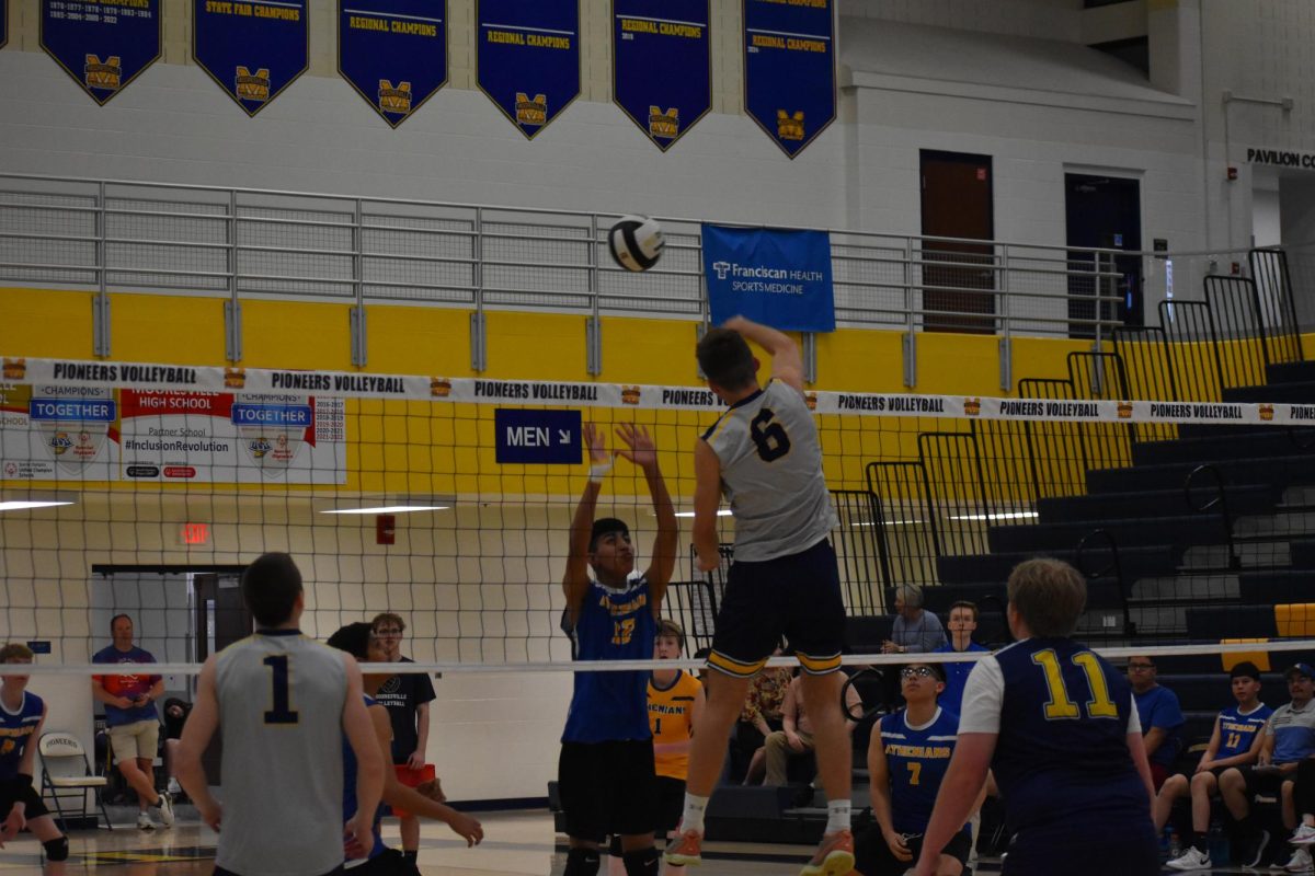 Senior AJ Defur slams the ball to the other team's side of the court. Defur's height gives him an edge during many games where he plays the front line. "I'm glad I joined the team, we all have a lot of fun" Defur said.