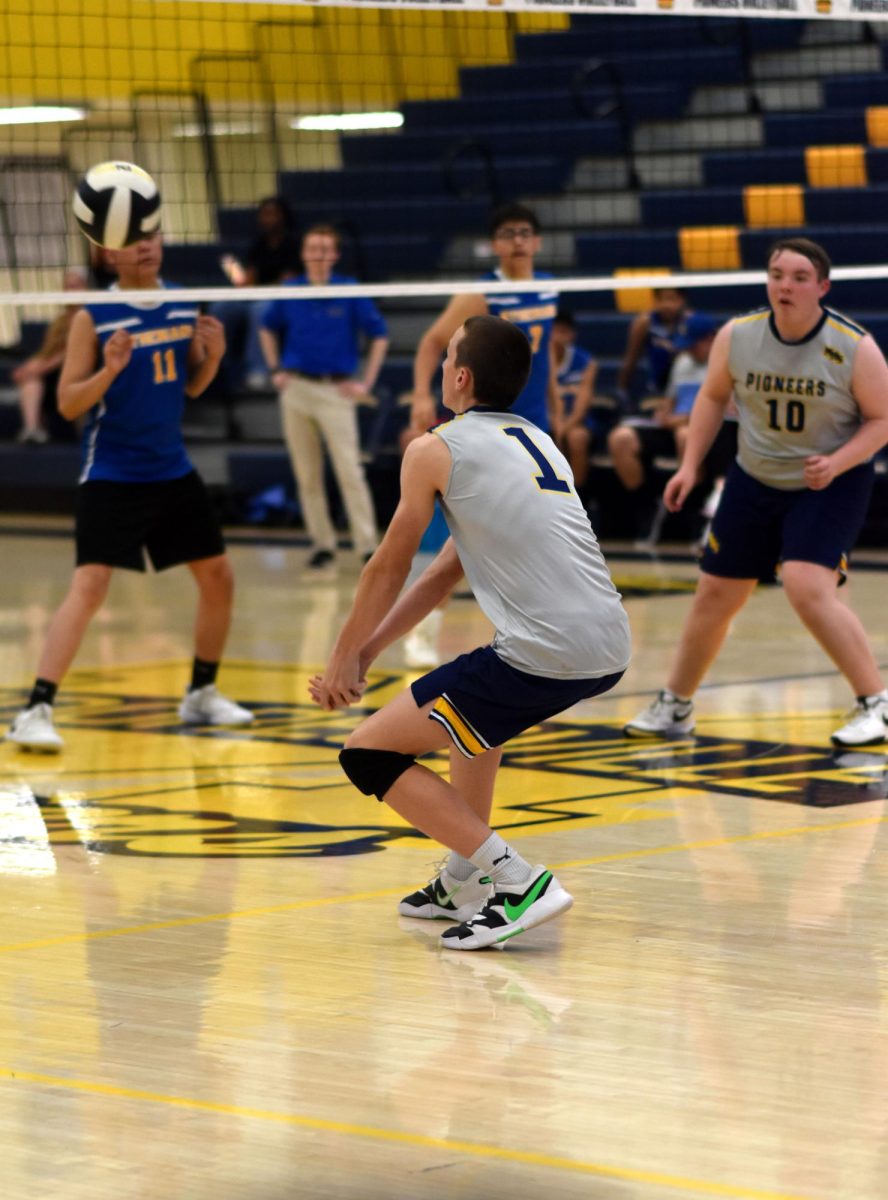 Senior Ben Coon bumps the ball for one of his teammates to set it. Coon was subbing in as the libero for a brief period during the game. "The game went well and we all played our hardest to get the win," Coon said.