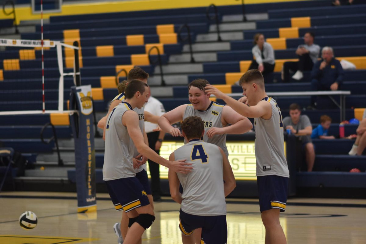 The team gathers around to bow down to Senior Seth Connor. After each time the team scores an ace they do this little ritual. "Every team celebrates an ace differently, and our school has always been unique on how we celebrate. This year we decided to do a bow towards the person who earned the ace for the team," junior Ty Stonehouse said.