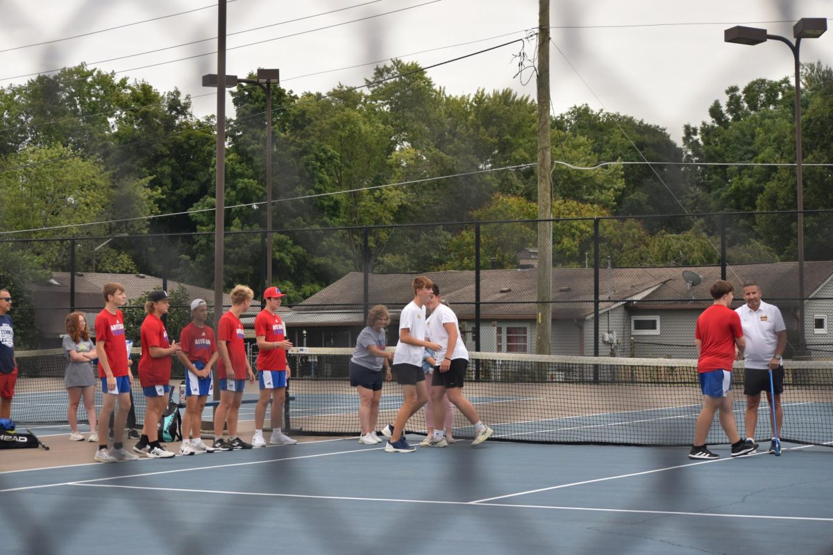 Senior Jared Kempf greets the Martinsville Artesians. They shake hands with both the coaches from their team and the opposing team. "We have to shake both our coaches and the other team's coaches hand to say good luck," Kempf said.