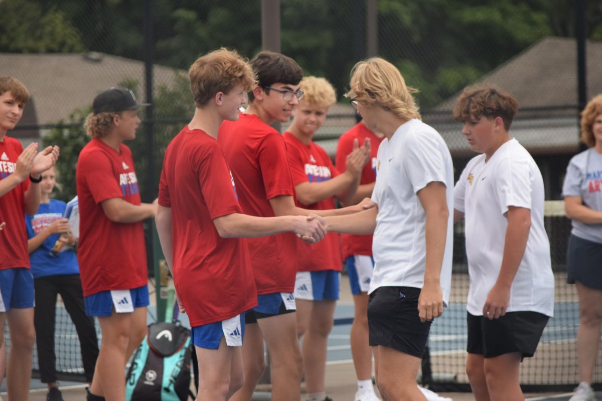 Senior Landon Stoner gives a hand shake to the Martinsville team players. They do this as a welcoming to their opponent. "It is a friendly gesture we give to our opposing team," Stoner said. 