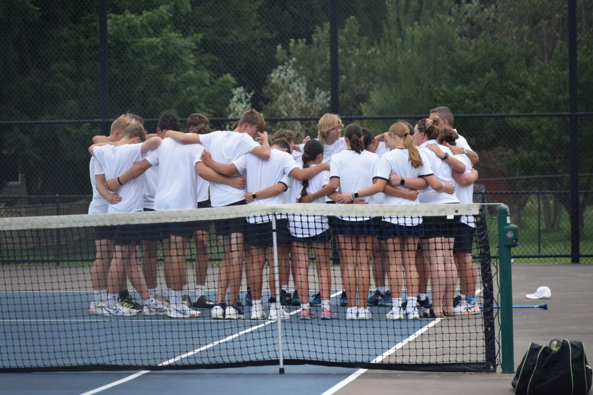 Junior Grayson Furniss huddles with the rest of his team. Coach Mike Teters talked to them about strategies they can use during the game. "We are given strategies and do our cheer before the game starts," Furniss said. 