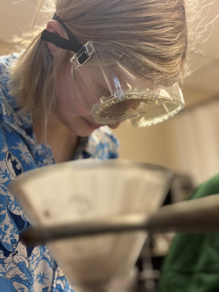  Junior Kayleigh Mills shows true excitement about her lab, yet she displays intense focus and concentration. Mills prepared for this lab by sitting through lectures taught by the department chair of science, Mrs. Kimberly Zook. “We were running a lab report on filtration and we were getting all of our data organized for our report,” Mills said. 
