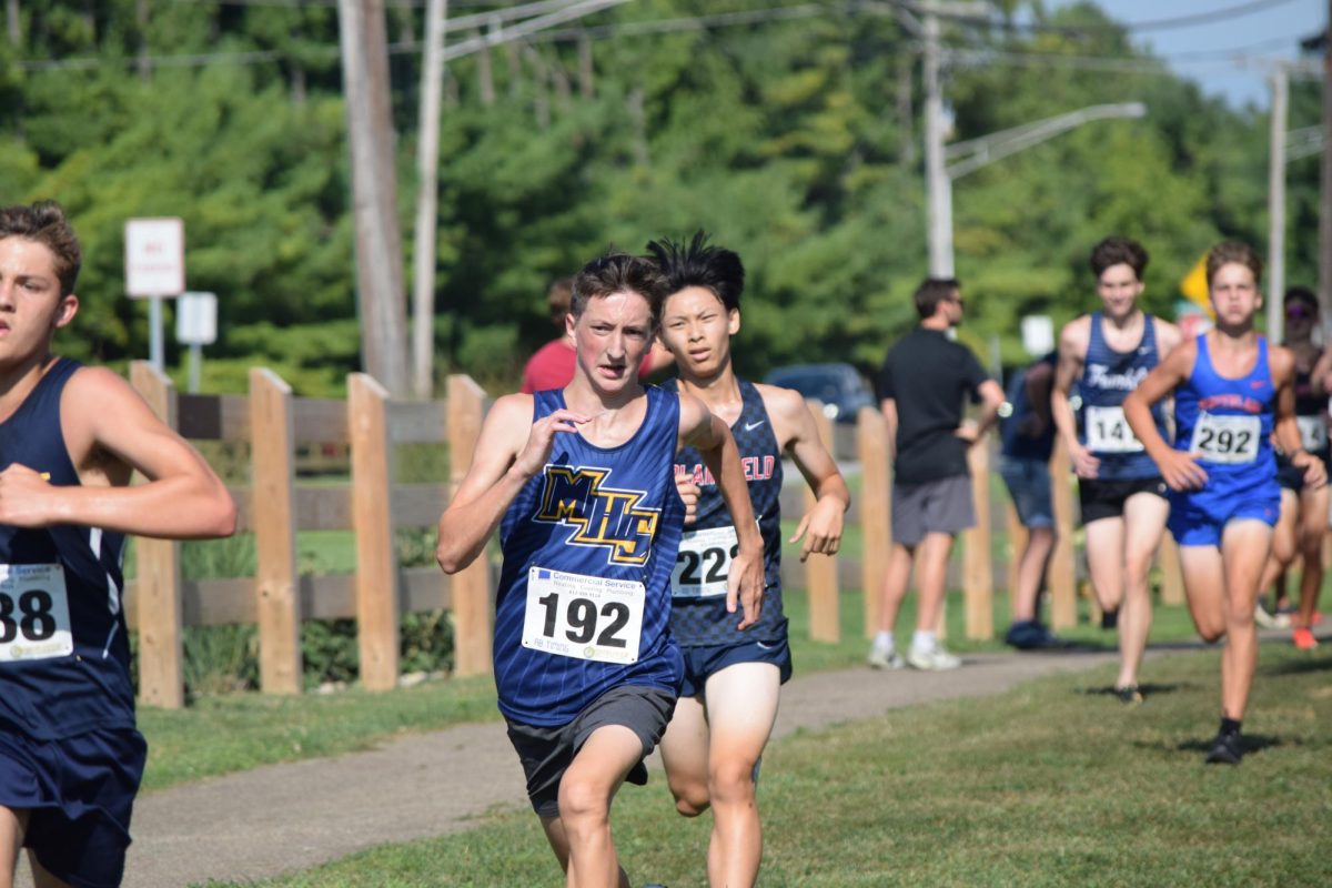 Sophomore Mason Reid chases down opponents at the Plainfield Relay. Towards the end of the race Reid felt tired, but determined to do well. “I can’t feel my body by that point; all I’m thinking is that I just need to beat the guy in front of me,” Reid said. 
