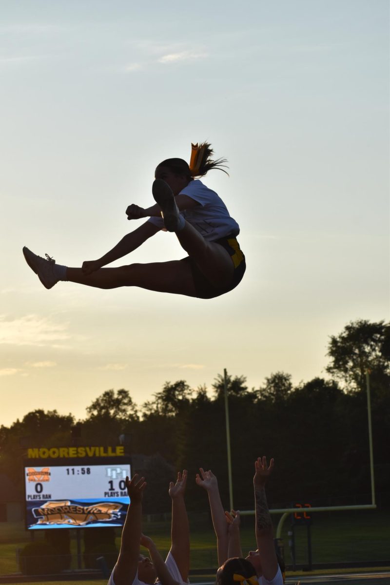 Junior Brandyce Knight gets thrown up in a toe touch basket. This is Knights fourth year cheering. “It was stressful, we ended up pulling through,” Knight said. 