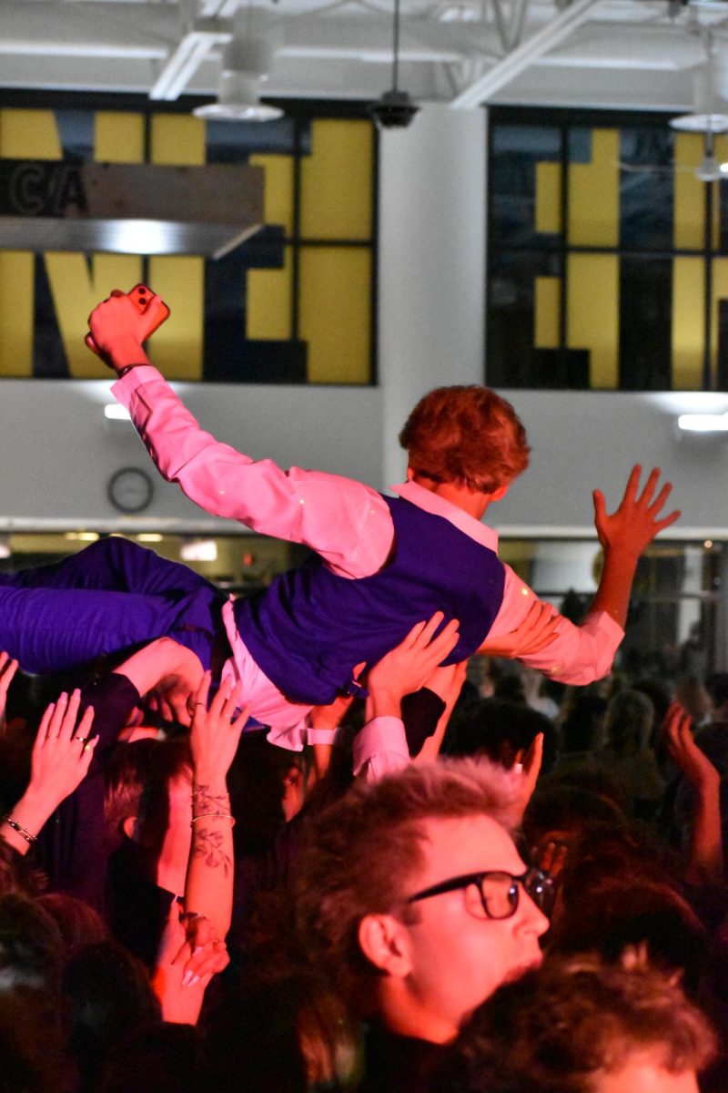 Sophomore Garnet Hauk crowd surfs along the entirety of the room during a song. Students were shocked that he was able to make it the whole way.