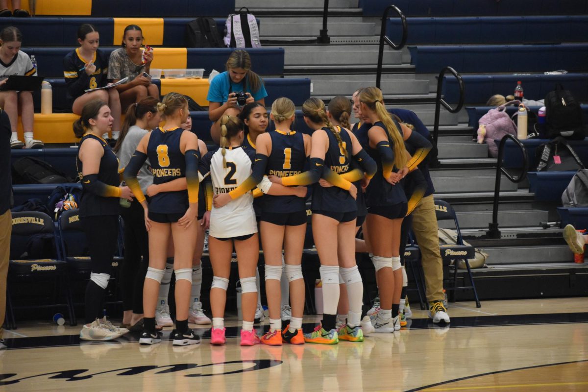 The girls volleyball team comes together in a huddle during their game against Franklin.