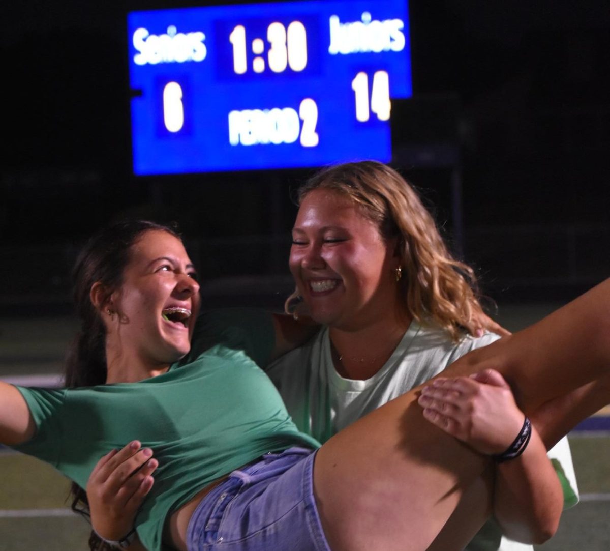 Junior Lilian Fox holds junior Jacey Bell in her arms. 