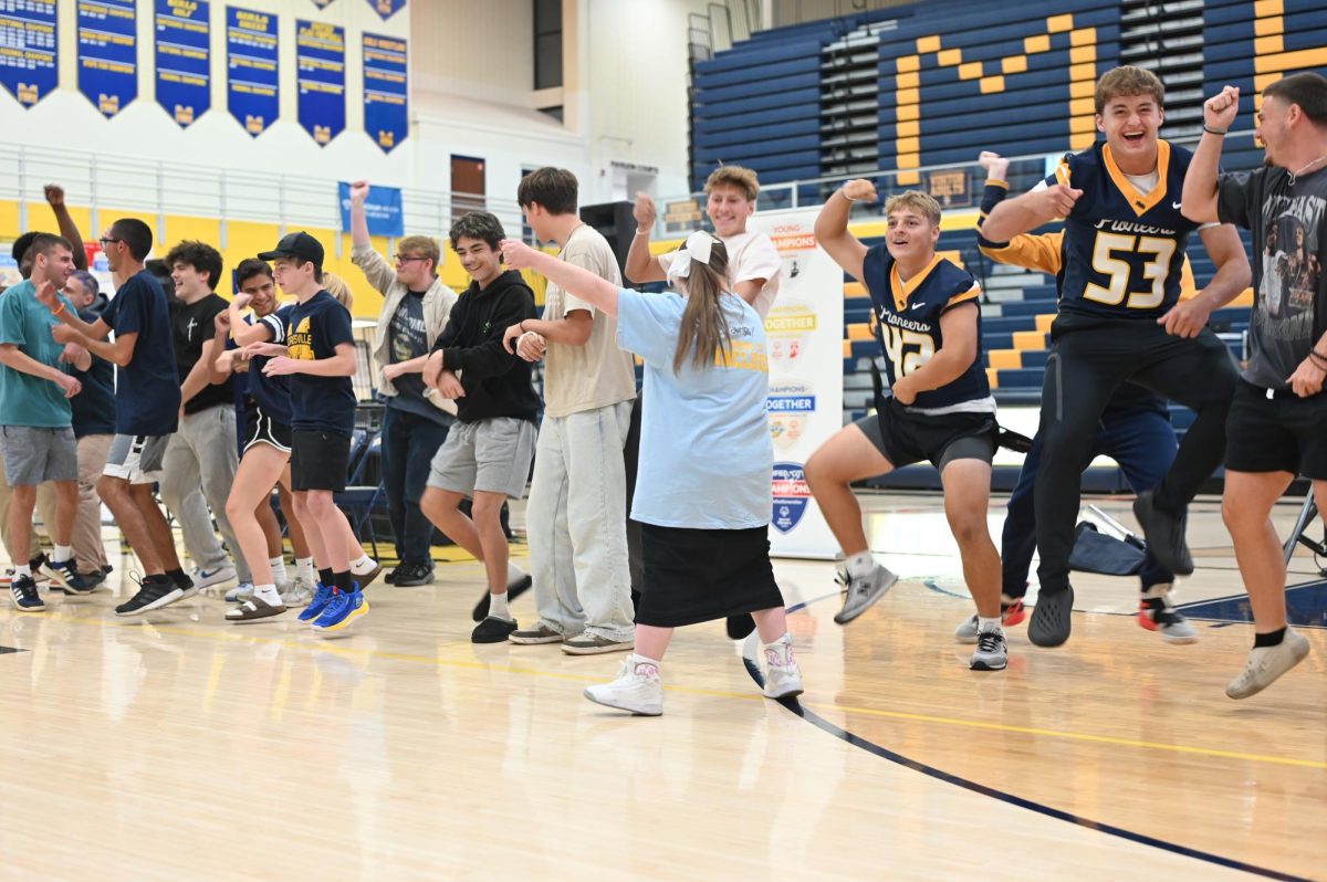 A large groups of students show off their best dance moves during the pep rally.