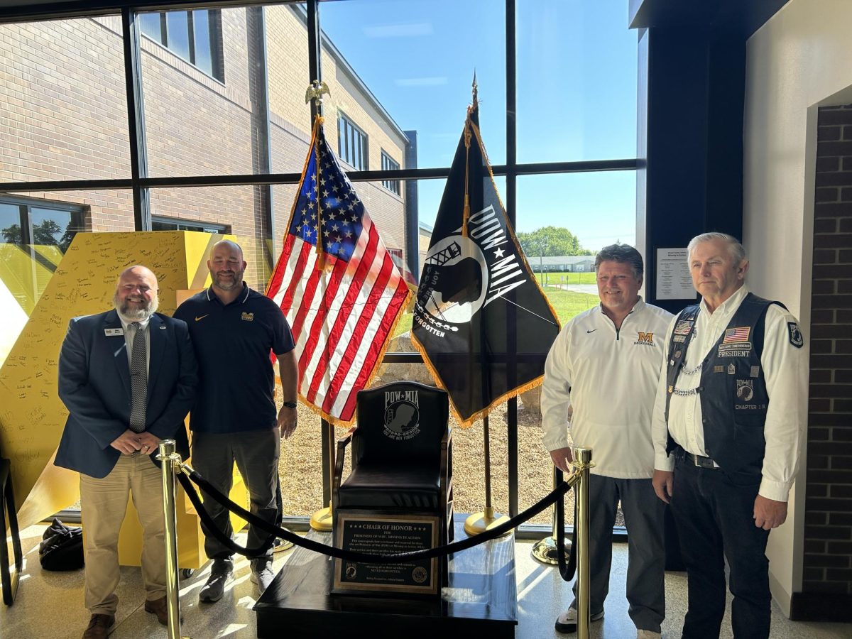 Principal Wes Upton stands with construction teachers Andy Mitchell and Terry Bradshaw, and Indiana Rolling Thunder President Mike Clark.