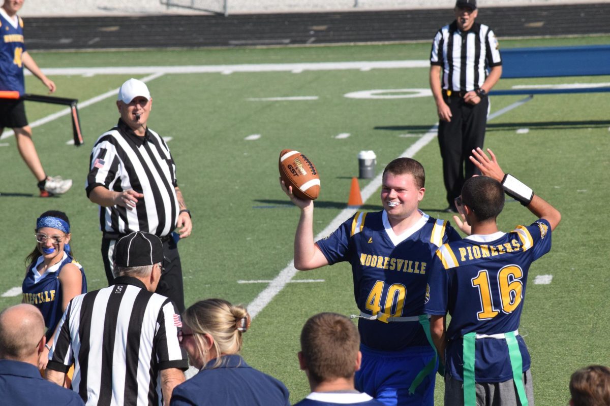 Members of the Unified Flag Football team cheer after making an interception on a play.
