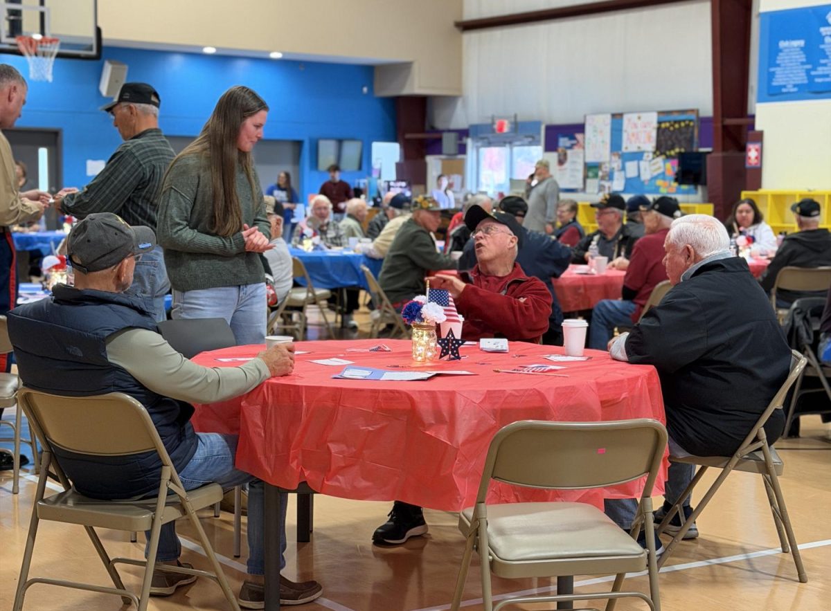 Senior Sidney Stultz talks among veterans, getting to hear many stories from their time in the service.